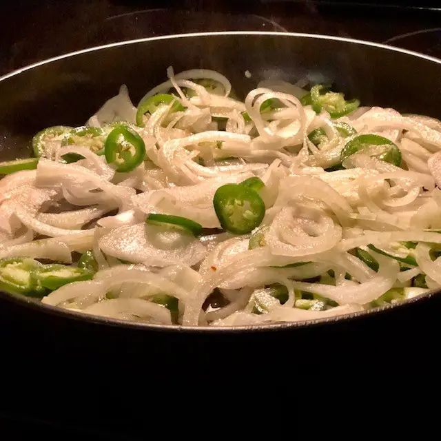 onions and pepper sauteeing on the stovetop