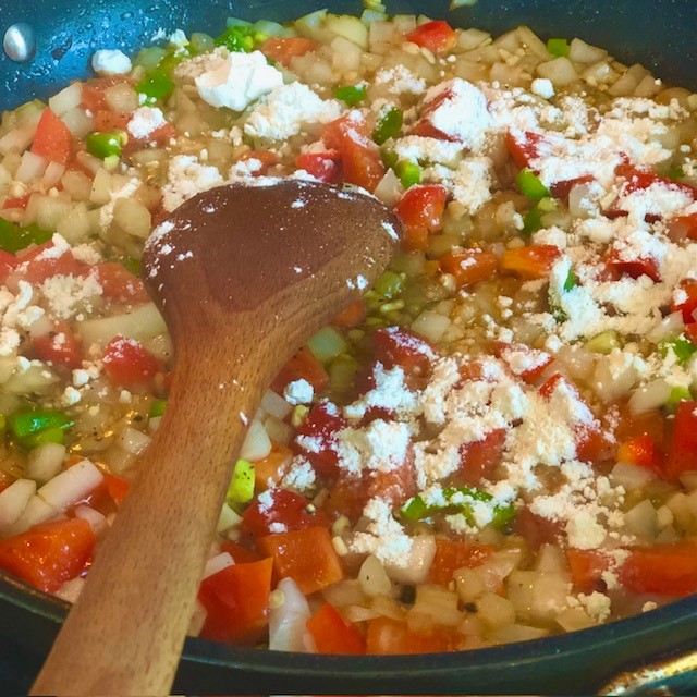 Adding flour to sauteed vegetables